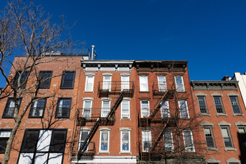 Row of Colorful Old Brick Residential Buildings with Fire Escapes in Williamsburg Brooklyn of New...