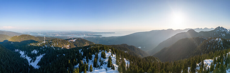 Tof of Canadian Mountain Landscape and City in Background. Aerial View. Vancouver, British Columbia, Canada.