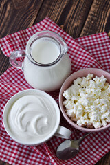 milk, cottage cheese and sour cream on a wooden table