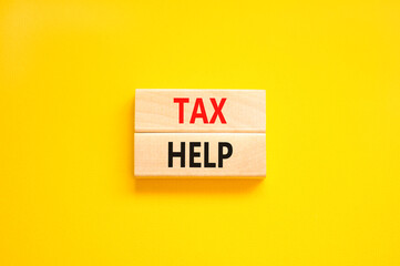Tax help symbol. Concept words Tax help on wooden blocks on a beautiful yellow table yellow background. Business, support and tax help concept. Copy space.