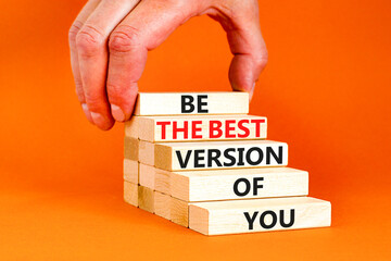 Motivational and inspirational symbol. Concept words Be the best version of you on wooden block. Beautiful orange background Businessman hand. Business motivational inspirational concept. Copy space.