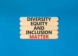 DEI Diversity equity inclusion matter symbol. Concept words DEI diversity equity and inclusion matter on wooden stick. Beautiful blue background. Business diversity equity inclusion matter concept.