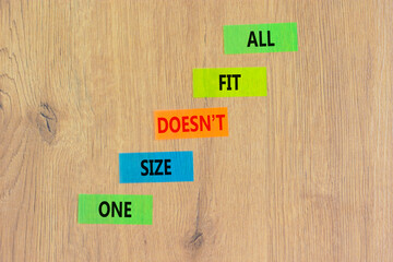 One size does not fit all symbol. Concept words One size does not fit all on colored paper. Beautiful wooden table wooden background. One size does not fit all business concept. Copy space.