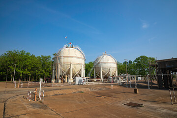 White spherical propane tanks containing fuel gas