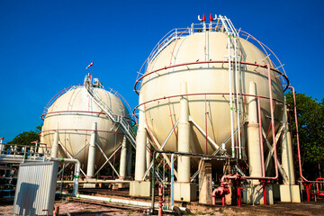 White spherical propane tanks containing fuel gas