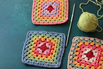 Handmade crocheted multicolored squares with embroidery patterns
