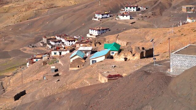 Traditional Spitian Houses of the Hikkim village on the dried Himalayan mountains of Spiti Valley in Himachal Pradesh, India. Houses of spitian architecture with grass on top of them in Hikkim village