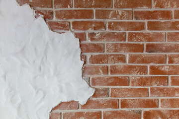 brick wall with a piece of white plaster