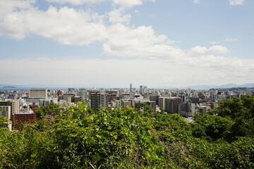Fototapeta na wymiar City view of Kagoshima and Sakurajima Volcano Mountain in Kagoshima, Japan - 日本 鹿児島 桜島 街並み