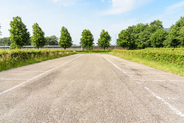 Fototapeta na wymiar Empty parking lot at a suburban park and ride facility on a sunny summer day