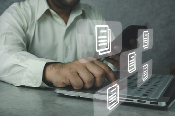 Document Management System, DMS working on laptop computer. Software for archiving, searching and managing corporate files and information. Online documentation database