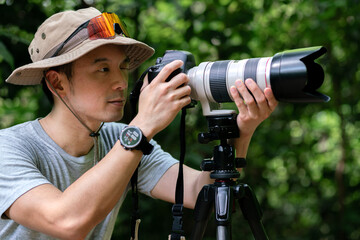 happy asian photographer travel and take photo with digital camera and backpacker trail trekking in...