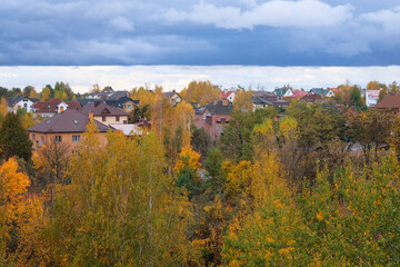 Autumn in country cottage. Bright sky with thick clouds. Warm weather. September, October, November.