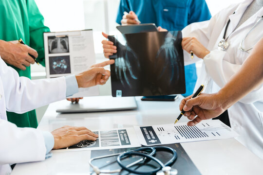 A team of young doctors discuss CT scan results in the clinic. Show patient results at the modern advanced diagnostic center. medical and health concept