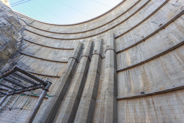 View of the high concrete dam from the bottom up.