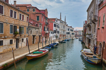 Obraz na płótnie Canvas Beautiful narrow canal with silky water in Venice