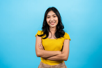 portrait, Asian girl wearing yellow shirt tight-fitting shirt stands with arms outstretched,...