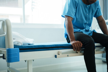 Fototapeta premium Close up view of male patient sit on hospital bed. Health care concept.