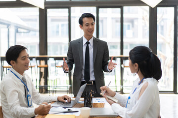 Group of young business people working and communicating at the office.