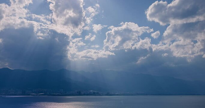 Time lapse of clouds and blue sky with Mountain and Lake