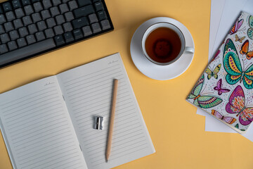 Obraz na płótnie Canvas cup of coffee and a notebook