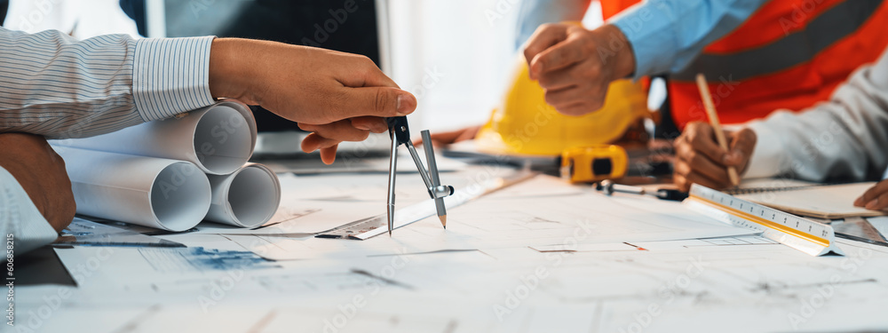 Wall mural Architect or engineer working on building blueprint, contractor designing and drawing blueprint layout with tool for construction project. Civil engineer and architecture design concept. Insight