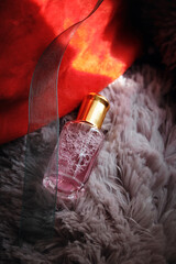 Perfumes for women. The perfume is lying on a soft toy.