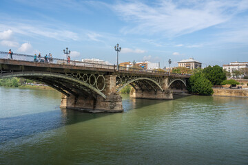 Fototapeta na wymiar Triana Bridge (Puente de Triana) at Guadalquivir River - Seville, Andalusia, Spain