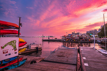 sunset sets the sky on fire over boat racks in toronto  inner harbour with billy bishop airport in...