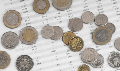 Coins on financial statement. Top view.