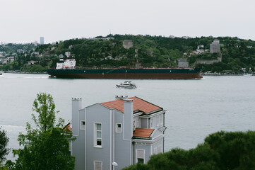 A ship passing through the Bosphorus and its view in anadoluhisari Istanbul, turkey