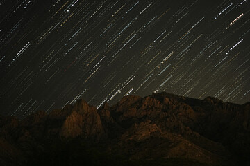 Mountain under the starry sky with star trail