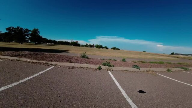 DJI avata fpv drone flying close over fields with clear blue sky 