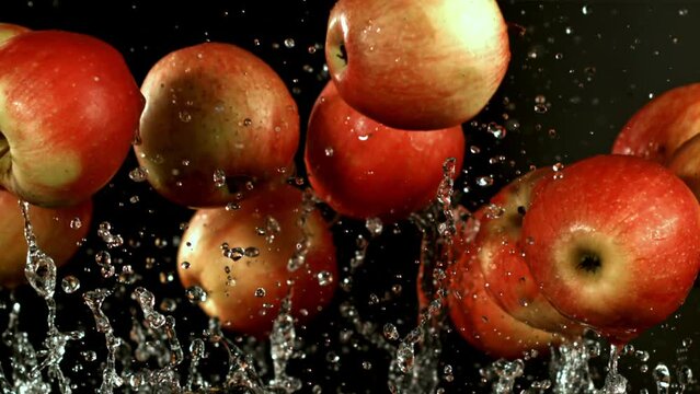 Apples fly up with water drops. Filmed is slow motion 1000 fps. High quality FullHD footage