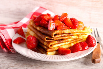 Stack of triangle folded crepes with strawberry