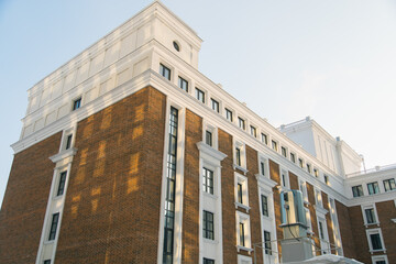 Fototapeta premium Part of Modern residential apartment with flat building exterior. Detail of New luxury house and home complex. Fragment of City Real estate property and condo architecture.