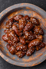 Chicken hearts fried in soy sauce with salt and spices in a plate