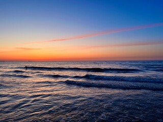 Fototapeta na wymiar Orange sky after the sunset at the sea, evening sea horizon 
