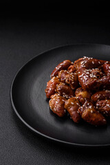 Chicken hearts fried in soy sauce with salt and spices in a plate