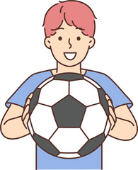 Cheerful boy of school age holding soccer ball and smiling offers to play football