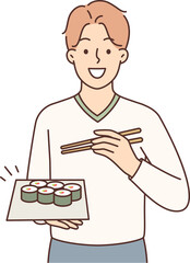 Man holding plate of maki rolls invites to dine in japanese restaurant with delicious healthy food