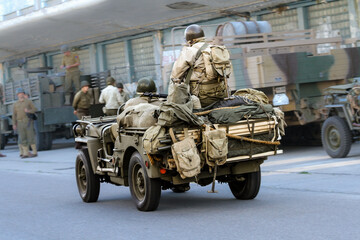 Historical reconstruction. American  soldiers during the Second World War. Infantry soldiers ride...