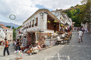 Gjirokastra, Albania - September, 2021: Souvenir shops in old town of Gjirokaster in Albania. Old...