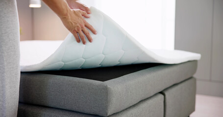 Mattress Topper Being Laid On Top