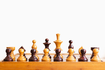 frontal photography of chess pieces of different colors, representation of equality, wooden game
