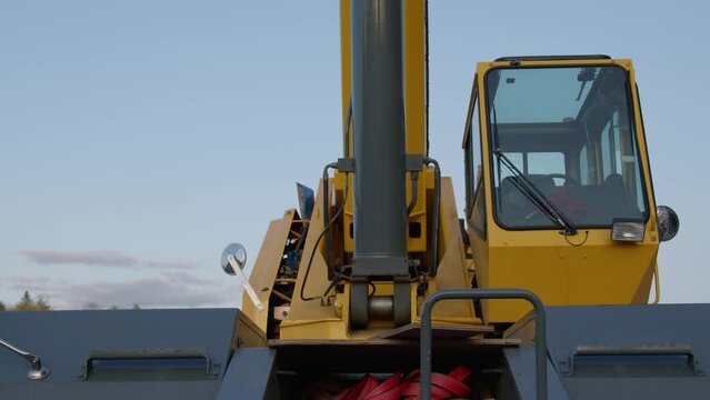 construction crane cabin industrial hydraulic equipment heavy powerful machine close up detail panning