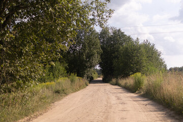 Fototapeta na wymiar Beautiful rural road in the countryside, day landscape