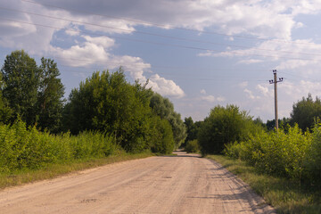 Fototapeta na wymiar Beautiful rural road in the countryside, day landscape