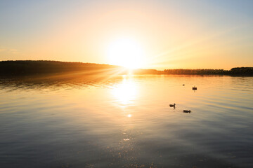 Evening landscape, sunrise or sunset on the lake or the sea