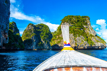 Koh Phi Phi Thailand with lagoon longtail boats limestone rocks.